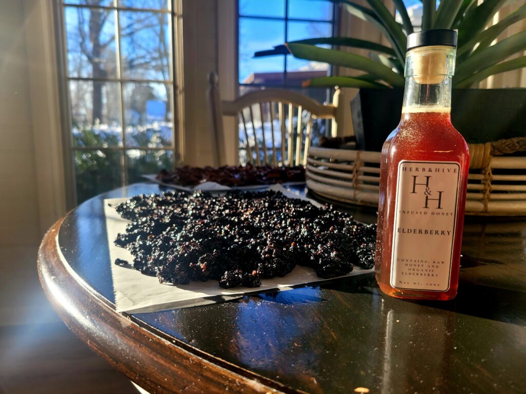 sun shining through honey on a table wtih herbs